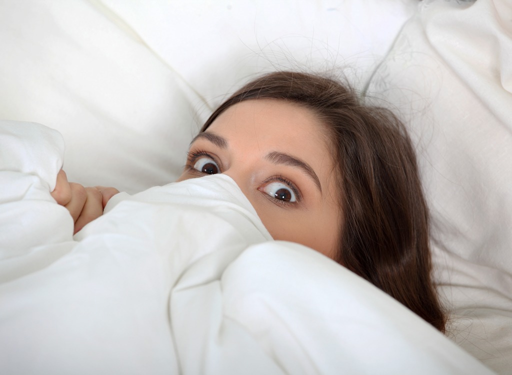 Woman in bed waking up nightmare.jpg