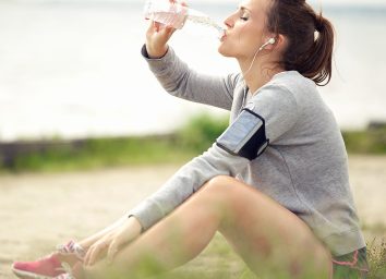 Woman drinking water after run