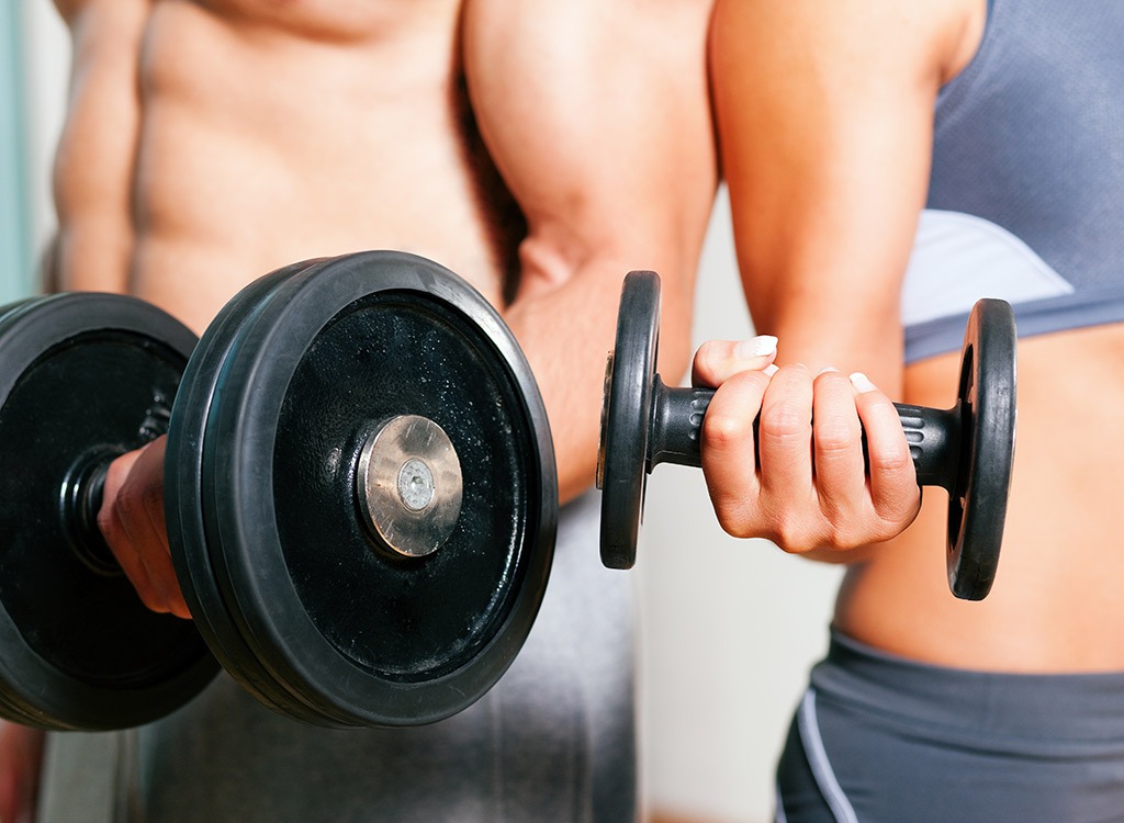 man and woman doing bicep curls