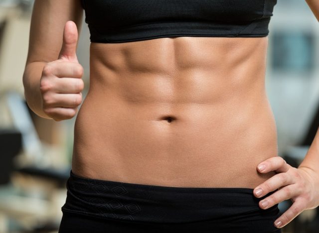 woman in sports bra with defined abs