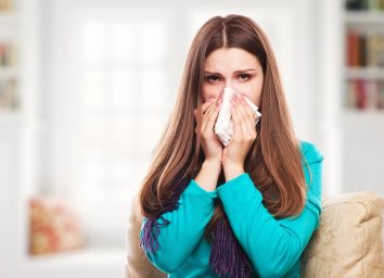 Sick woman sneezing