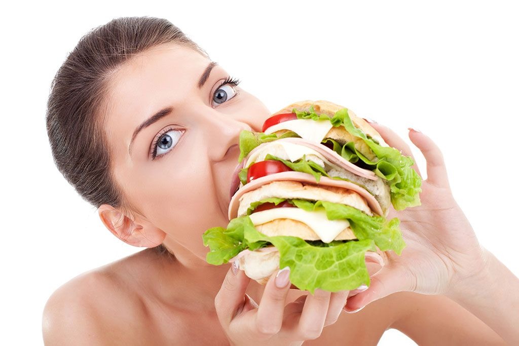 Woman eating giant sandwich.jpg