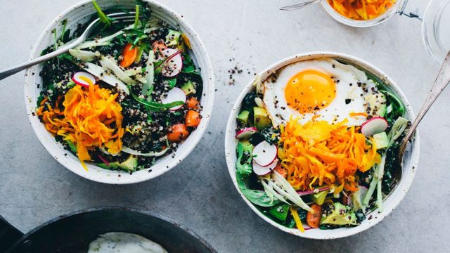 Green salads in bowls with eggs