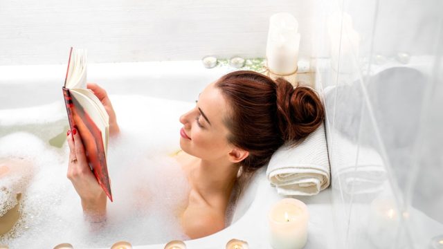 woman reading in a bath