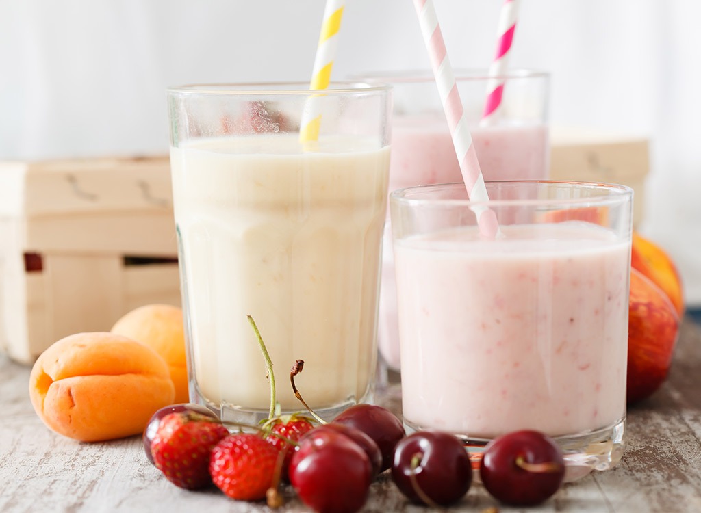 Glasses of fruit smoothies with straws