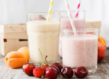 Glasses of fruit smoothies with straws