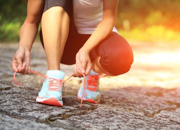 Woman tying running shoes