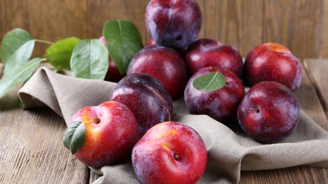 group of plums on table