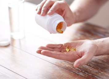 omega 3 fish oil pills in hand