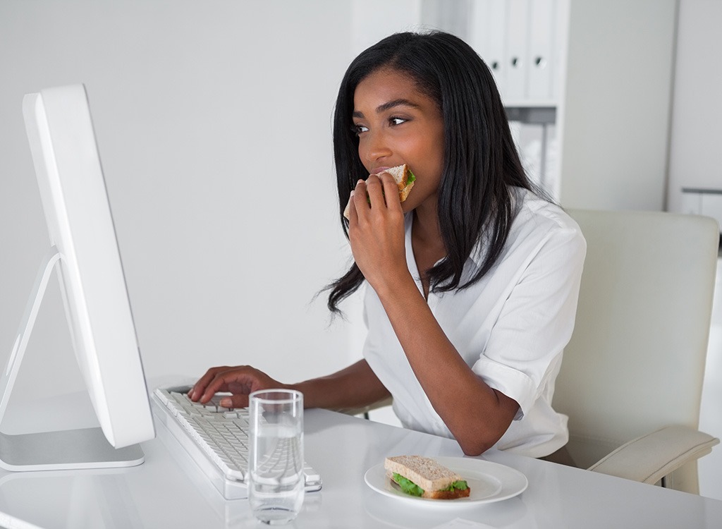 woman eating desk