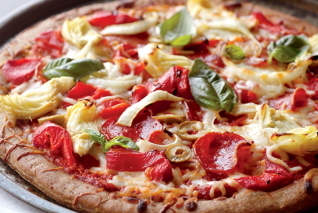 Pizza with onions pepperoni and basil