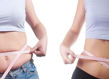 Woman weight loss measuring waist