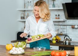 Healthy woman making salad
