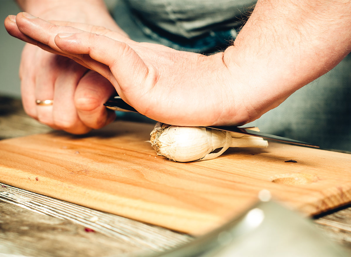 crushing garlic with a knife