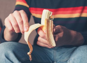 Man peeling banana to eat