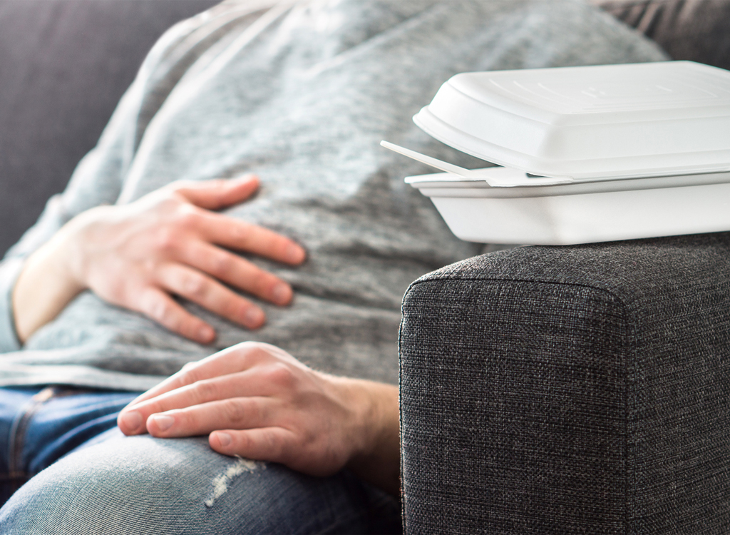 Man suffering digestive distress after overeating