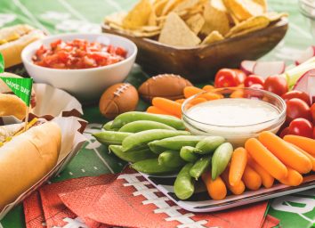 Superbowl appetizers including crudite, chips and salsa