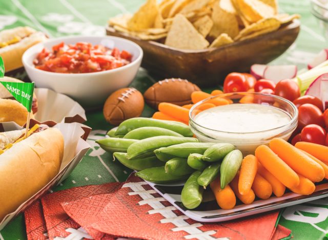 Superbowl appetizers including crudite, chips and salsa