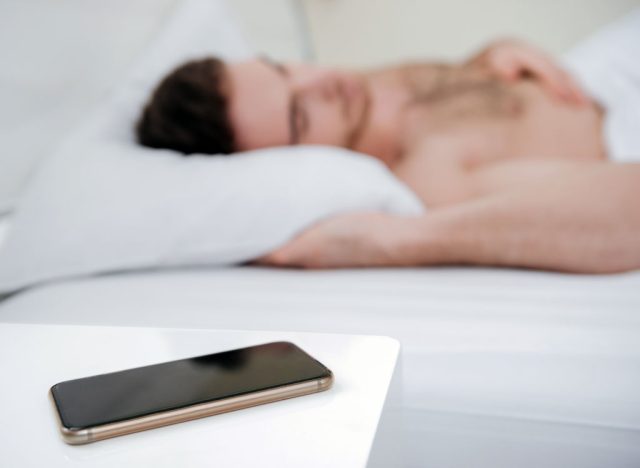 Man sleeping phone bedside