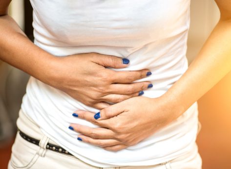 Woman holding bloated stomach belly