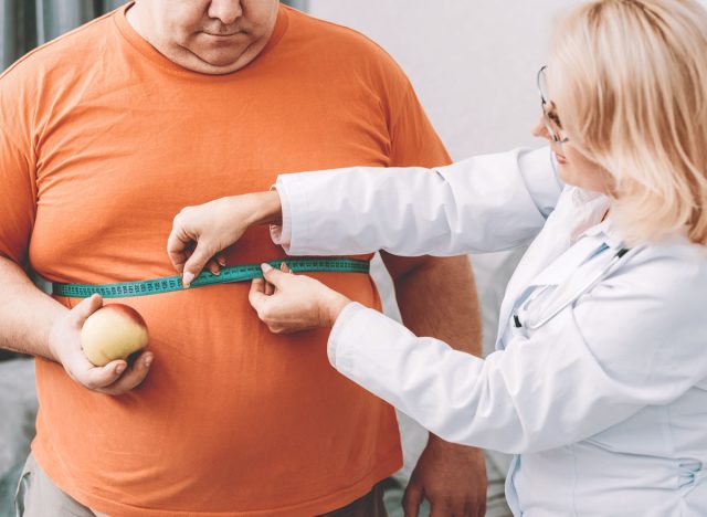 Doctor measuring man chest for bmi overweight fat