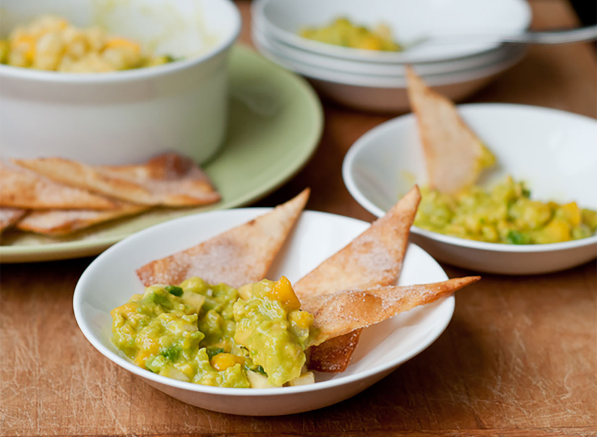 fruity guacamole on plates with chips