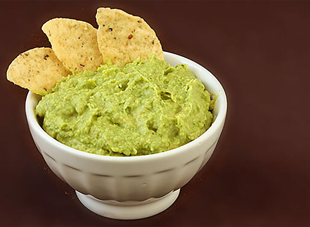 guacamole hummus in bowl with tortilla chip