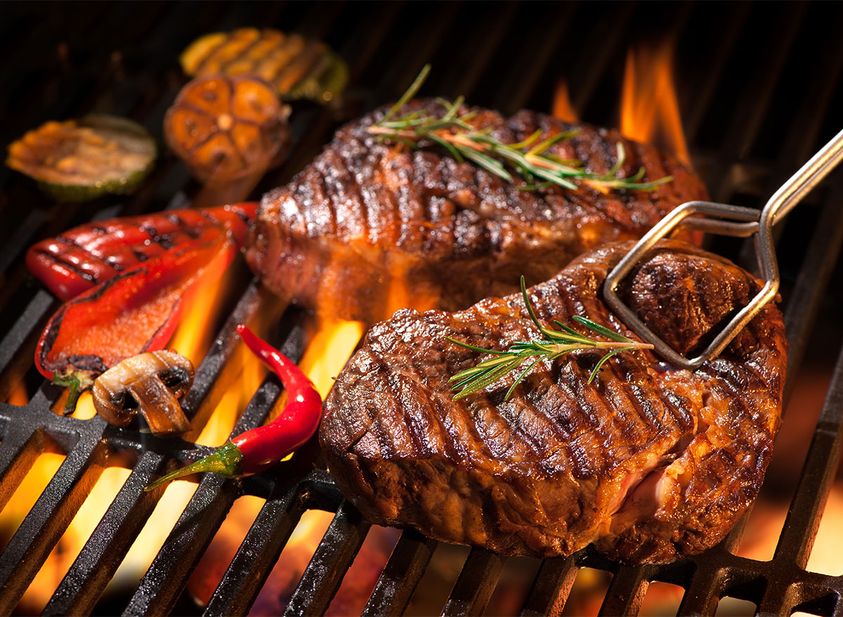 grilled steak with tongs