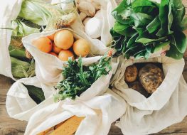 shopping for organic food in reuseable grocery bags