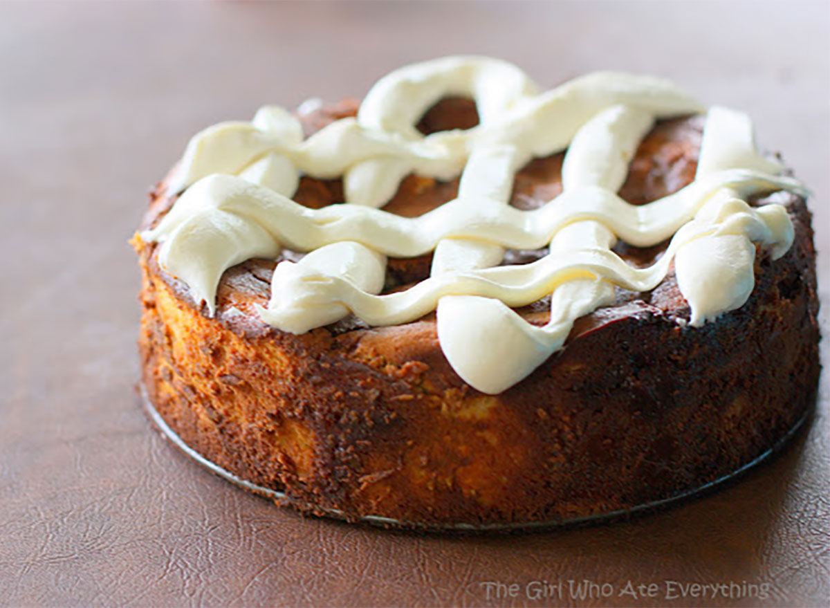 whole cinnamon roll cheesecake topped with frosting