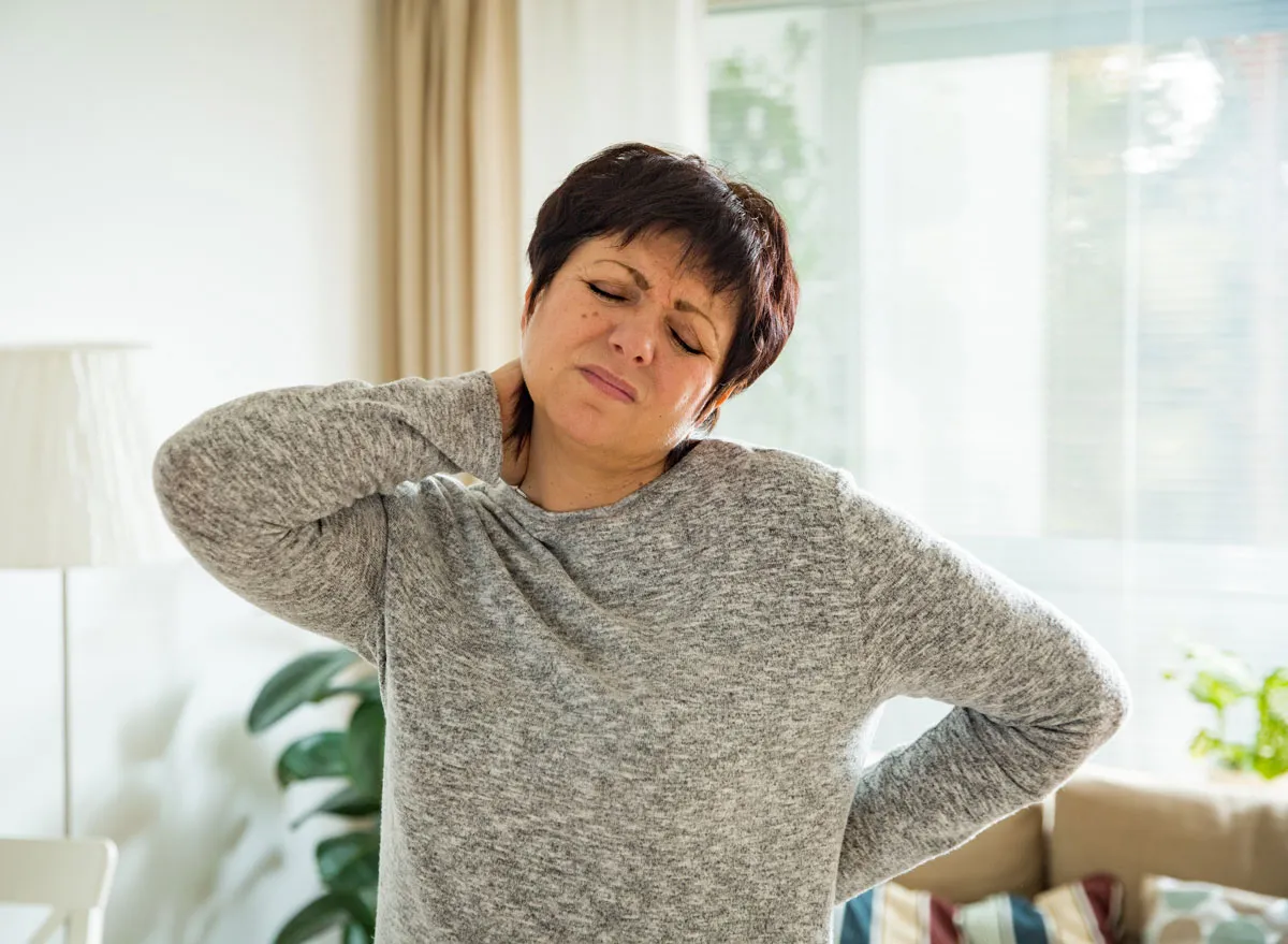 Woman holding sore neck