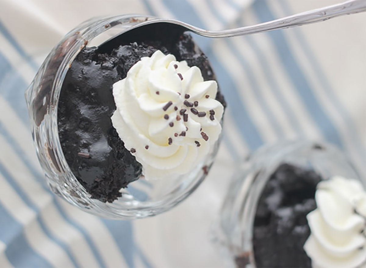 slow cooker pudding cake in bowls with whipped cream