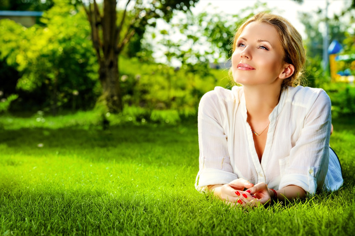 woman lying on a grass outdoor