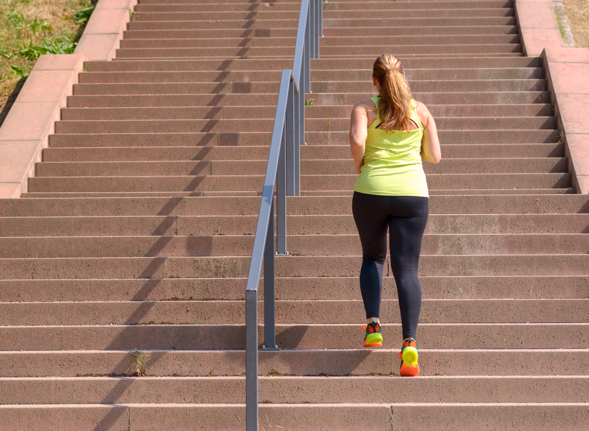 A woman walking up the stairs to exercise