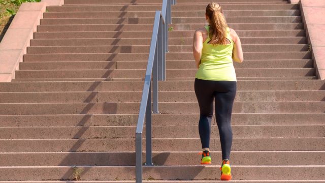 Woman walking up stairs to exercise