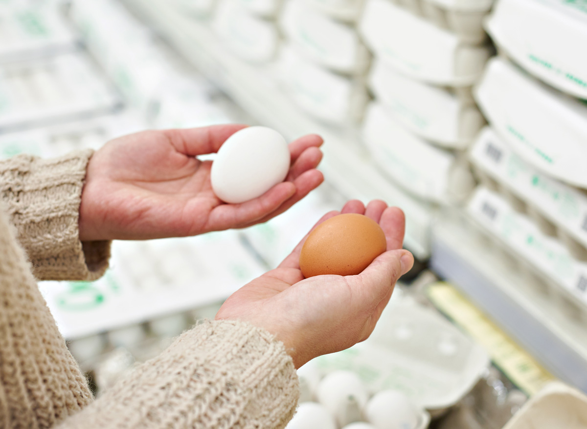 https://www.eatthis.com/wp-content/uploads/sites/4/2017/05/woman-at-store-holding-white-brown-egg.jpg