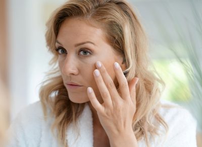 Aging woman looking at wrinkles