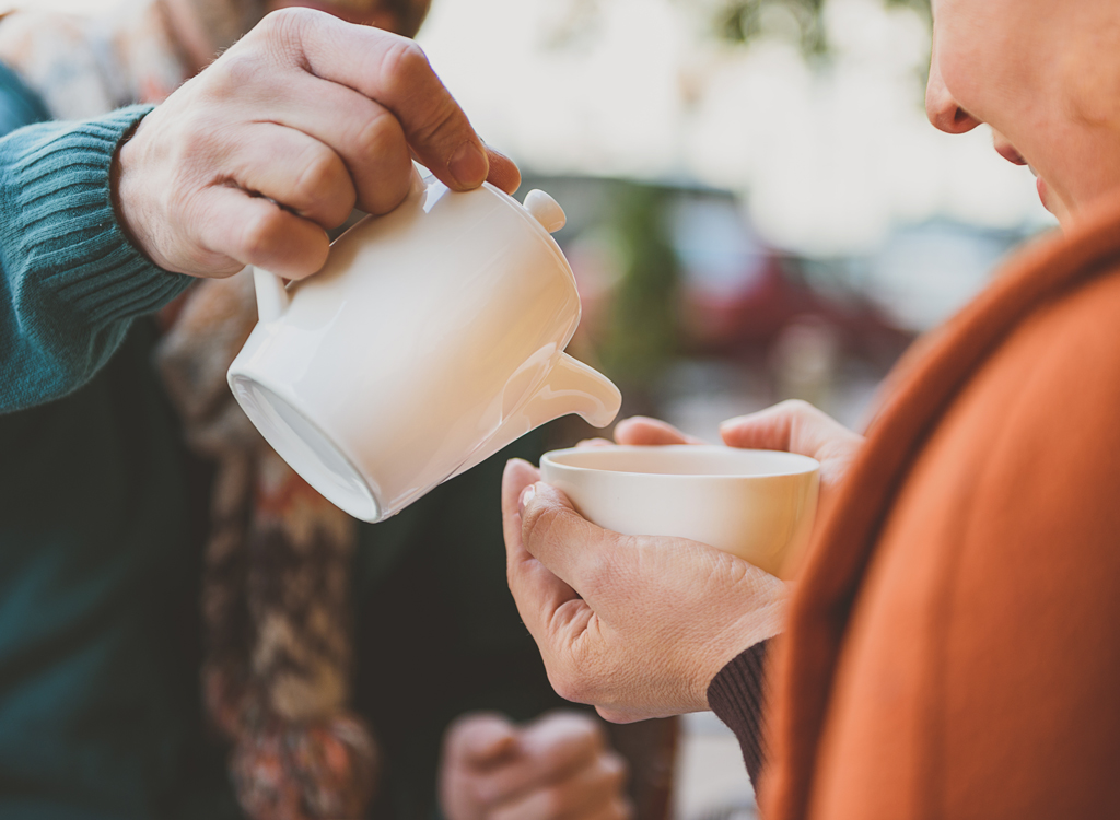 Couple pouring cup tea