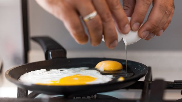 crack eggs into frying pan