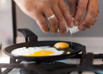 crack eggs into frying pan