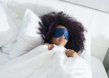 woman sleeping in bed with eye mask