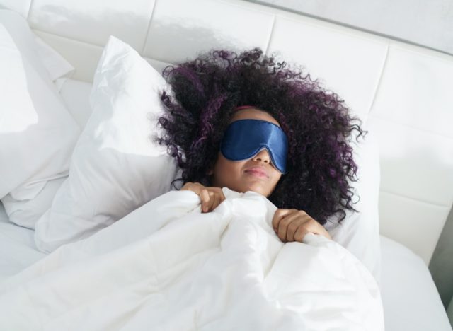 woman sleeping in bed with eye mask