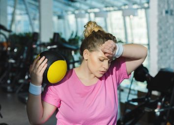 woman sweating and tired after exercising a workout