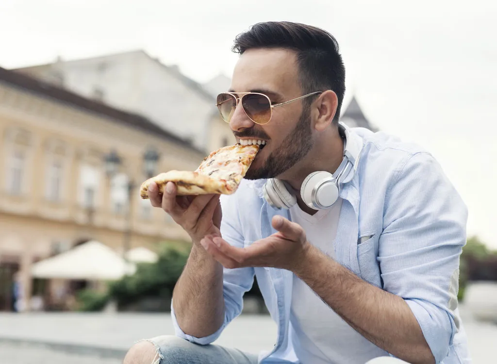 man eating pizza