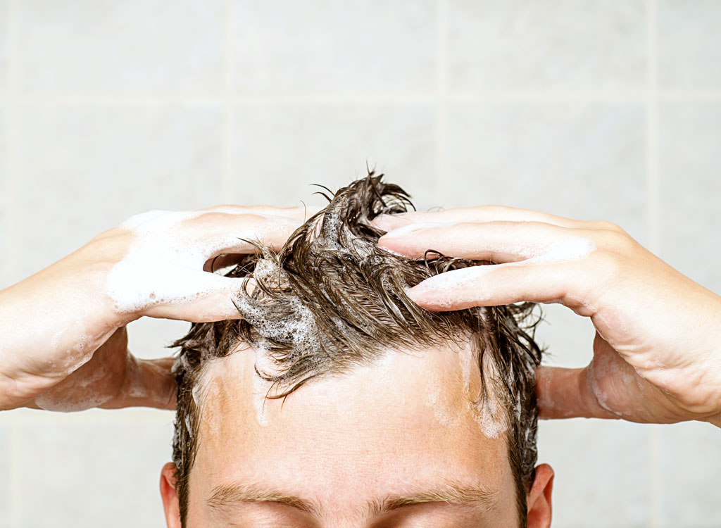 man shampooing hair