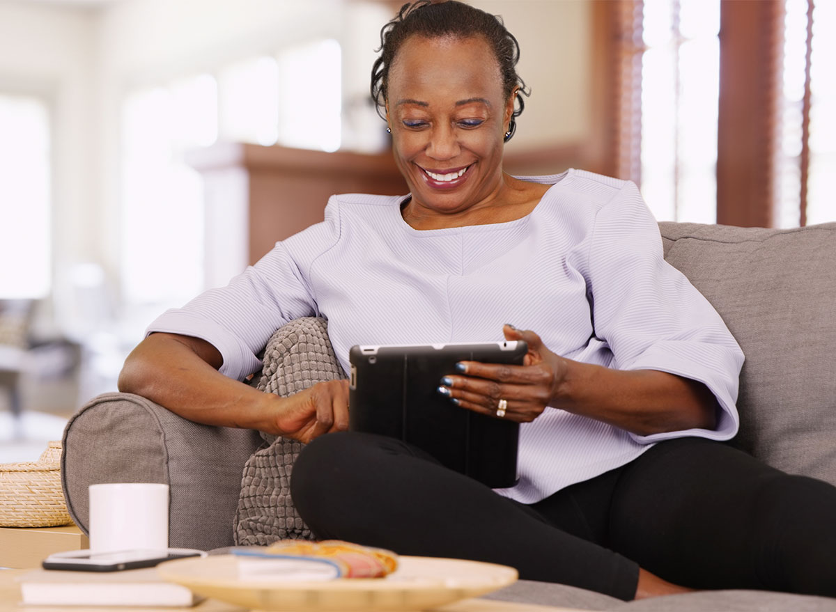 older black woman looking at tablet