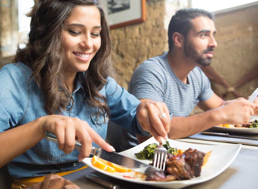 Woman eating steak