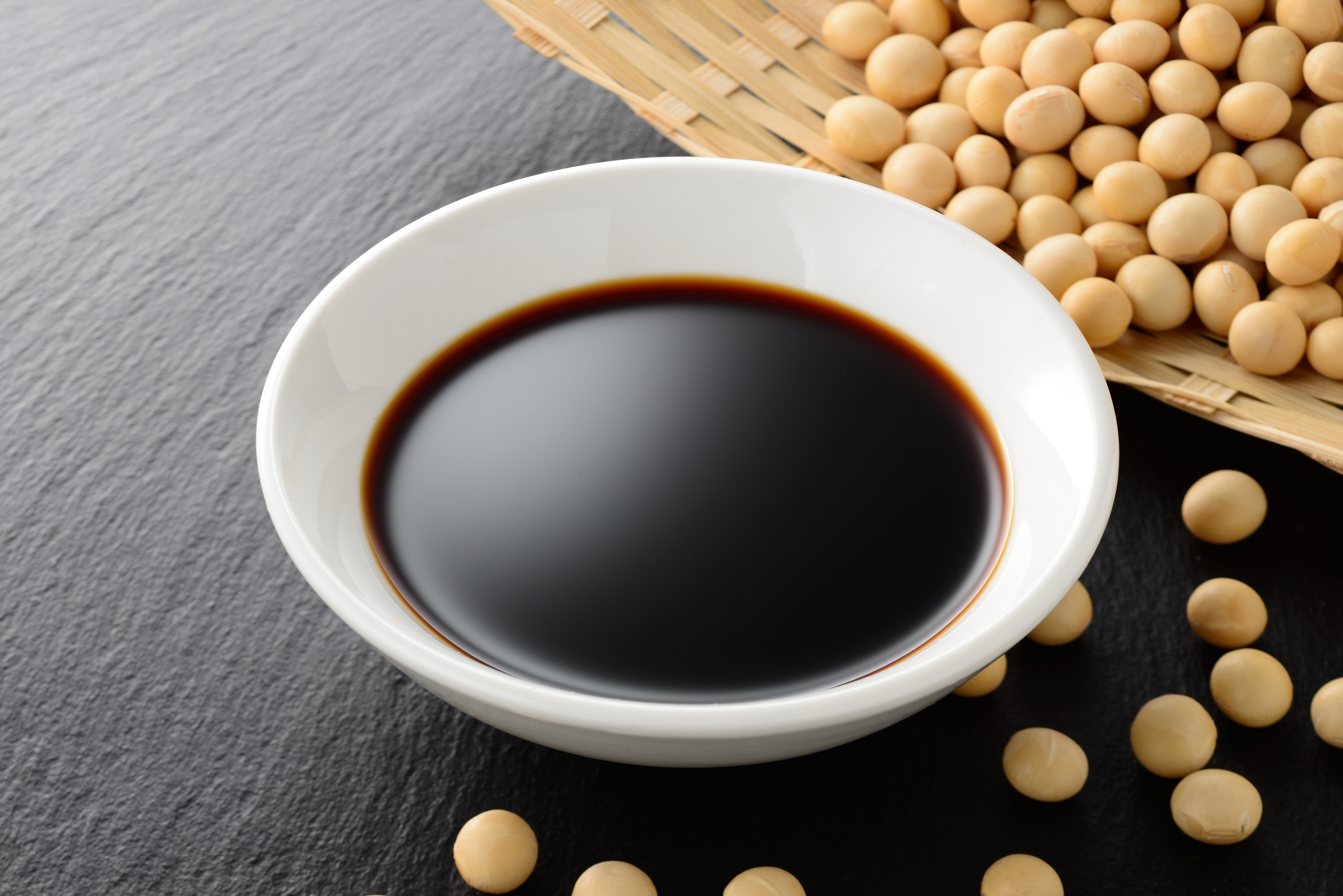 dipping bowl of soy sauce with soy beans