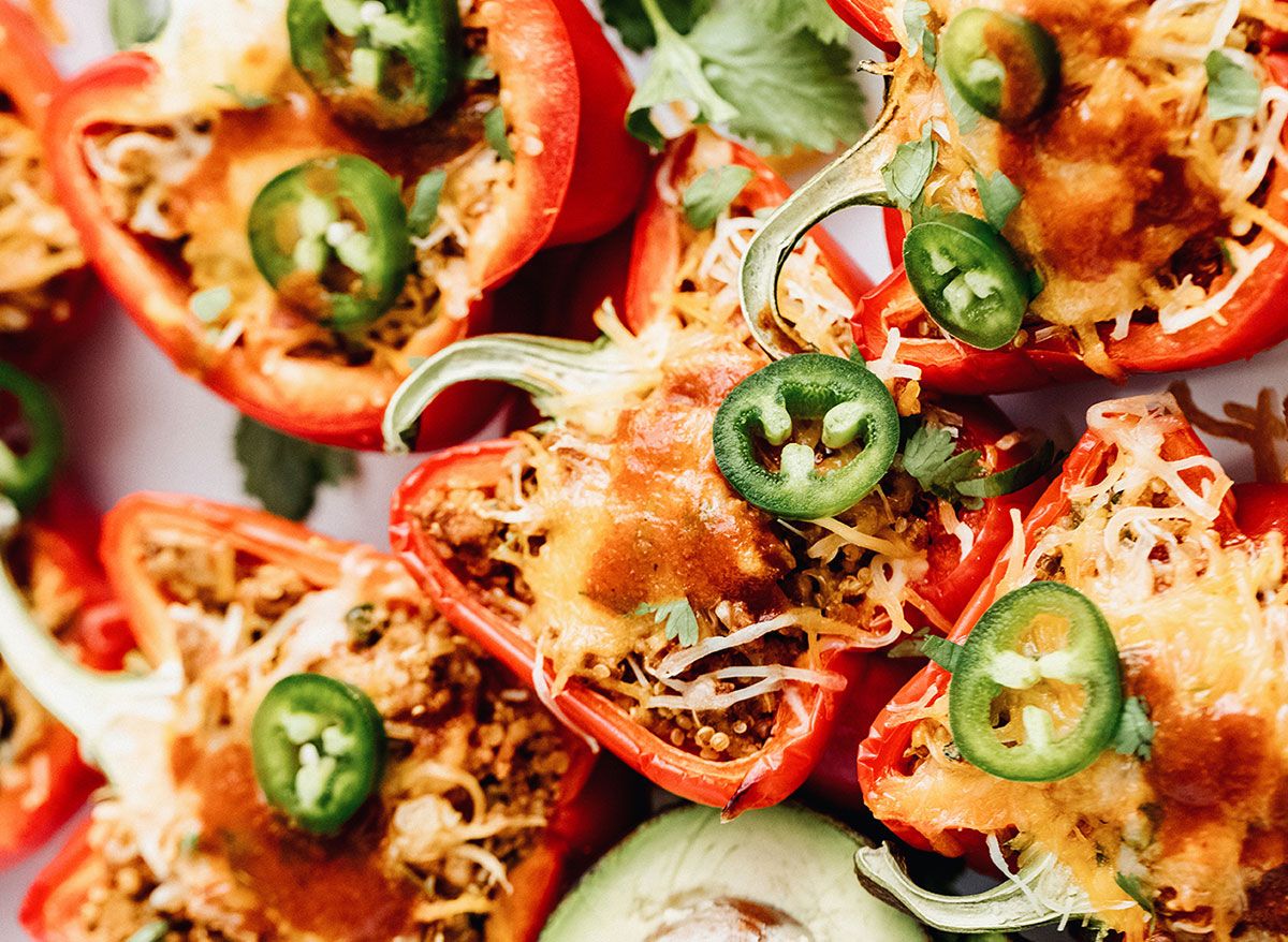 chicken and quinoa stuffed bell peppers topped with jalapeno slices