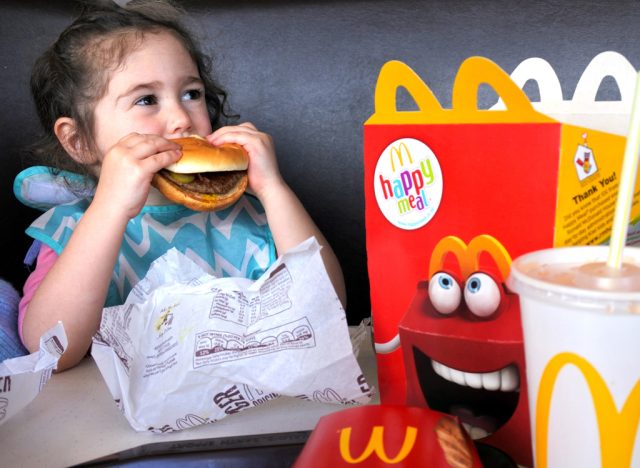 Child eating Mcdonalds happy meal
